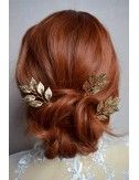 Pics à cheveux avec feuilles dorées.